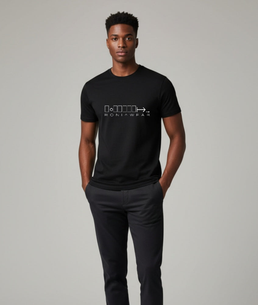 Man wearing a black t-shirt with a logo and text, standing against a plain background