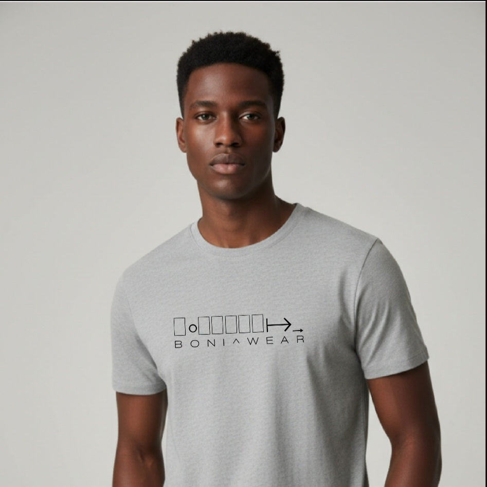 Man wearing a gray t-shirt with a logo on a plain background