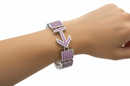 Bracelet with pink gemstones on a wrist against a white background