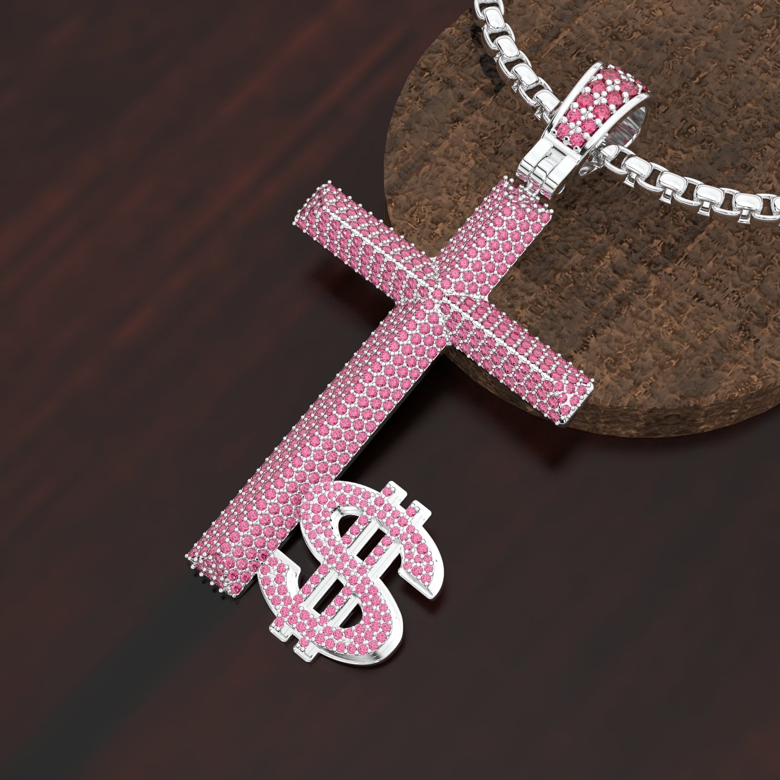 Pink cross and dollar sign pendant on a dark surface
