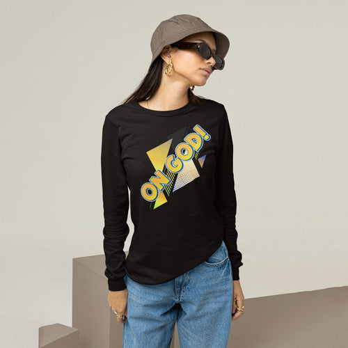 Person wearing a black long-sleeve shirt with colorful text, blue jeans, and a cap.