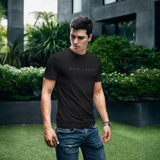 Man wearing a black t-shirt with 'BONIWEAR' logo outdoors.