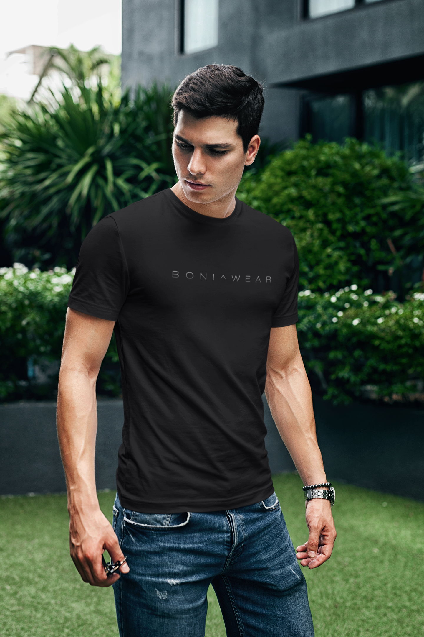 Man wearing a black t-shirt with 'BONIWEAR' logo outdoors.