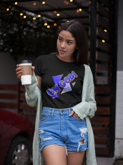 Woman wearing a black t-shirt with colorful "ON GOD " text, holding a coffee cup outdoors.