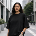 Young female model in untucked black oversized t-shirt and cargo pants